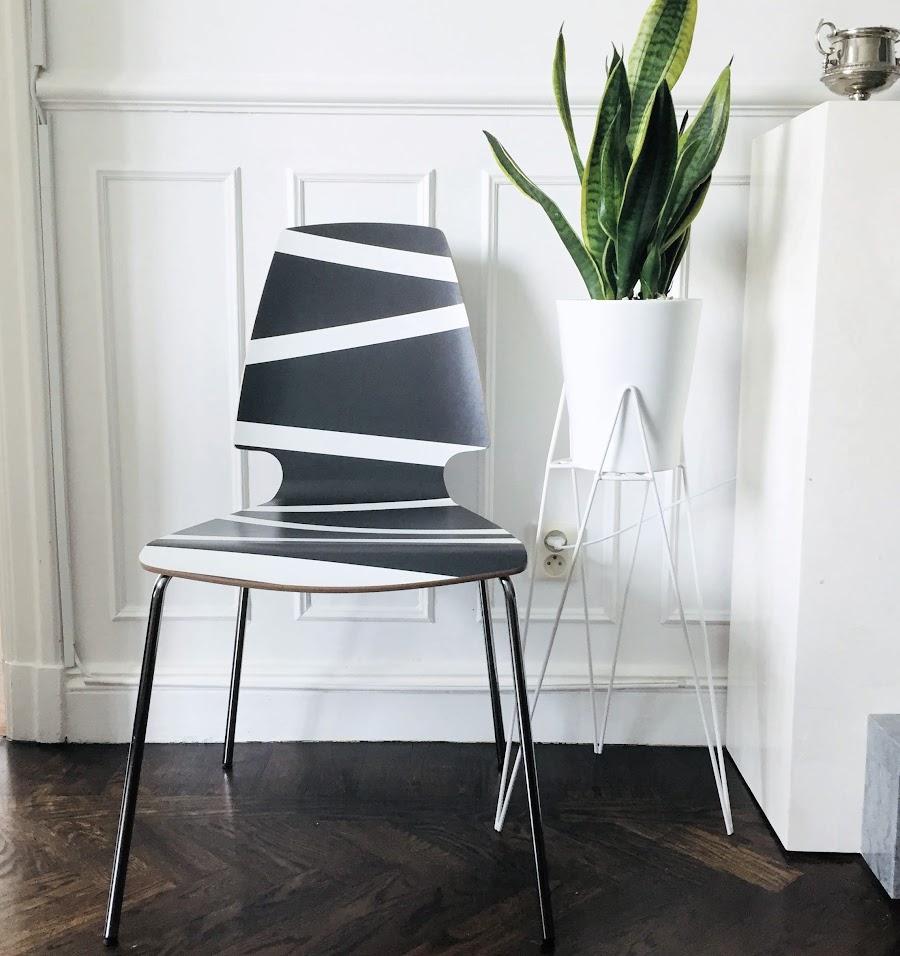 A photo of a modern chair and plant